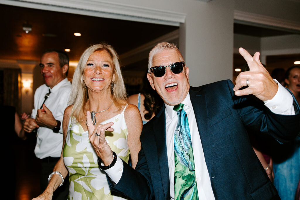 High-energy dance floor photo with guests cheering