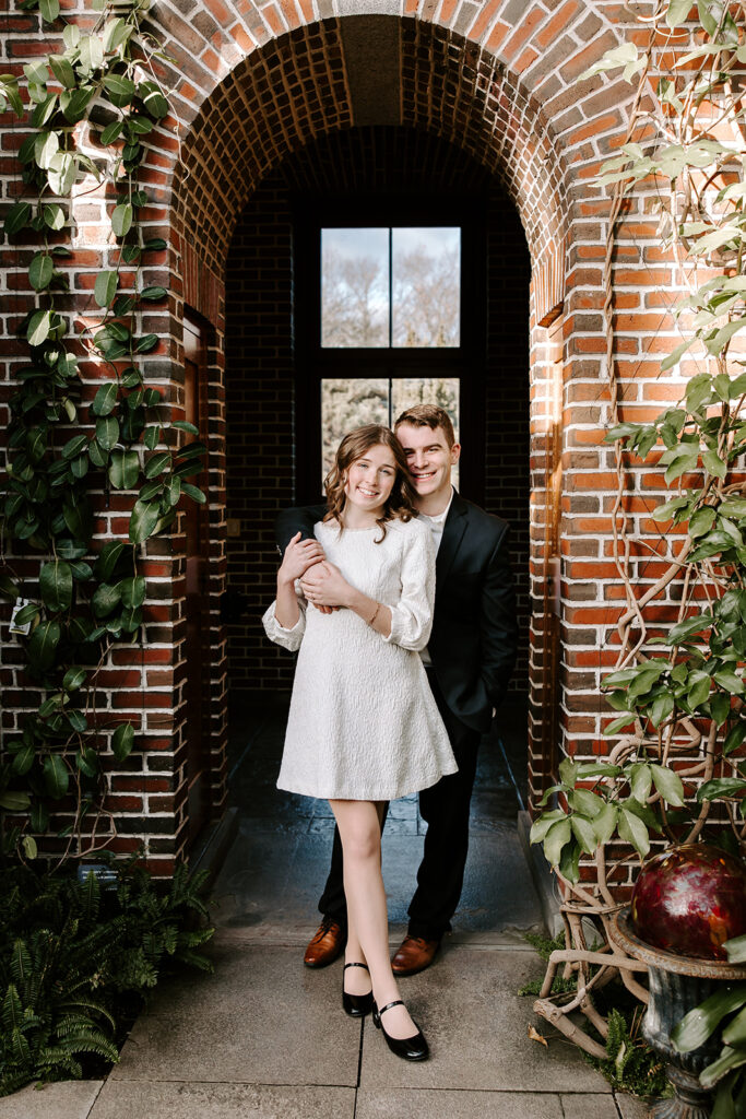 engagement photos under brick archway
