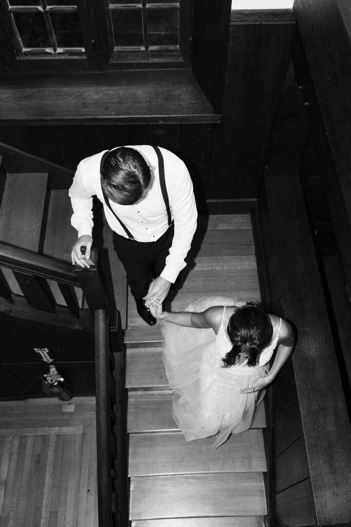 black and white of couple walking towards reception