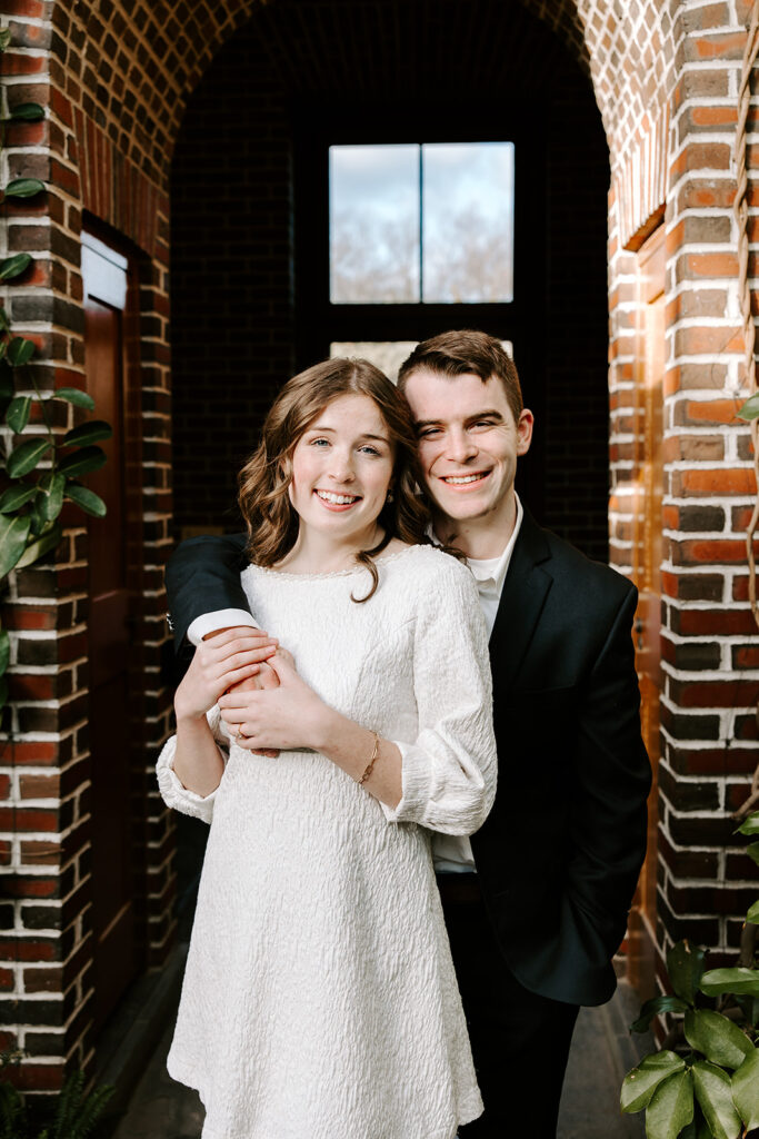 Romantic close-up of couple surrounded by indoor garden florals
