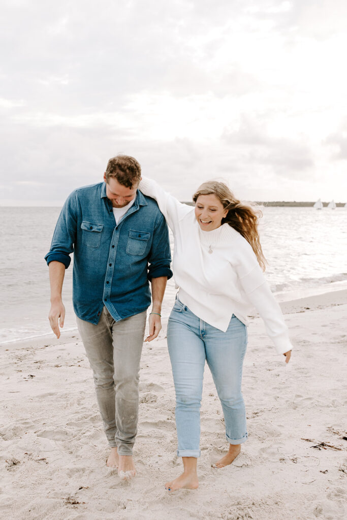 couple walking along beach shoreline