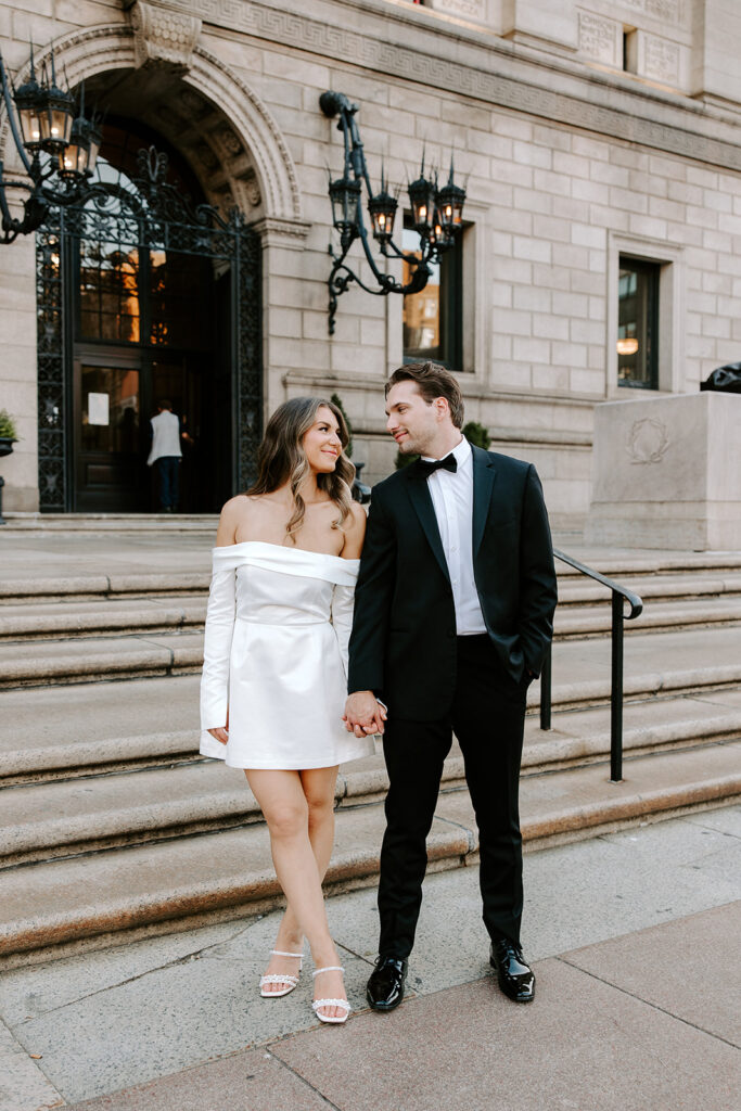 Close-up of couple holding hands in front of iconic library backdrop