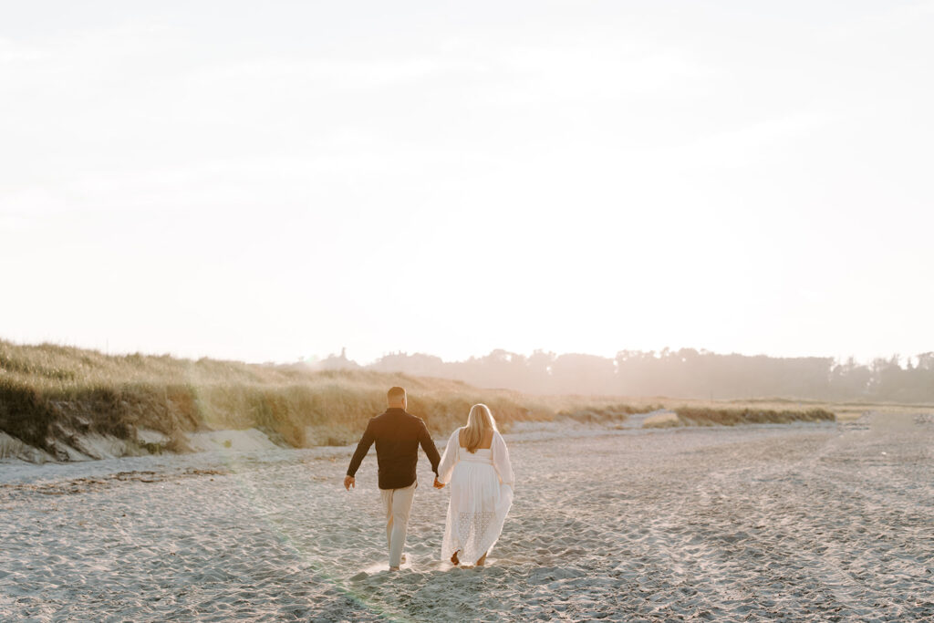 Sunset glow over Crane Beach with couple holding hands