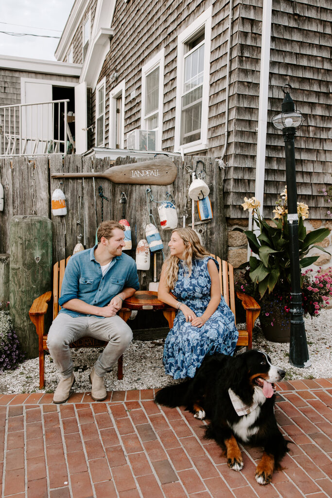 Romantic engagement photo in front of seaside shops in Woods Hole