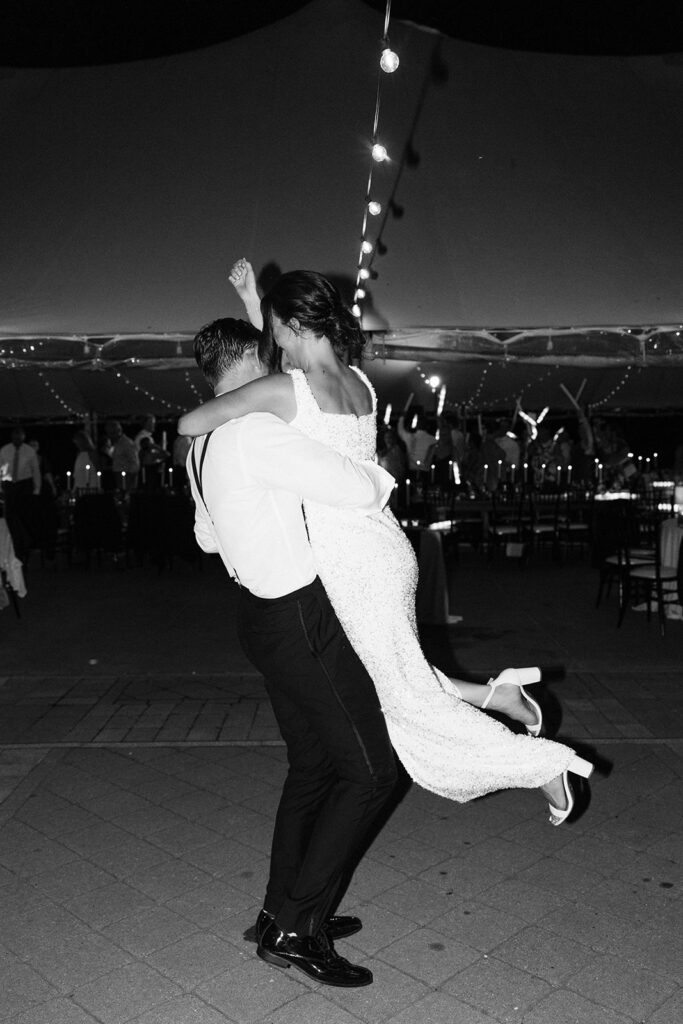 groom spinning bride around in her second dress