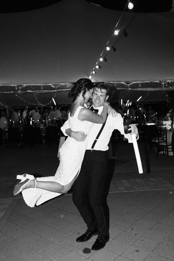 groom picking up bride to dance