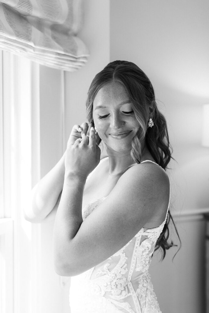 bride putting jewelry on