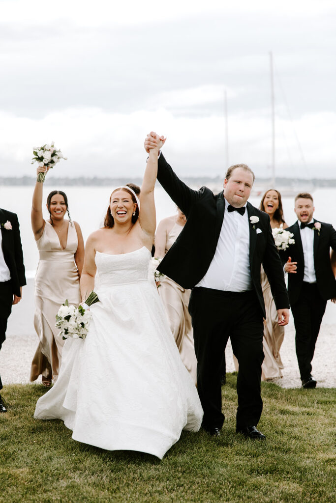 Full wedding party group photo on Belle Mer lawn