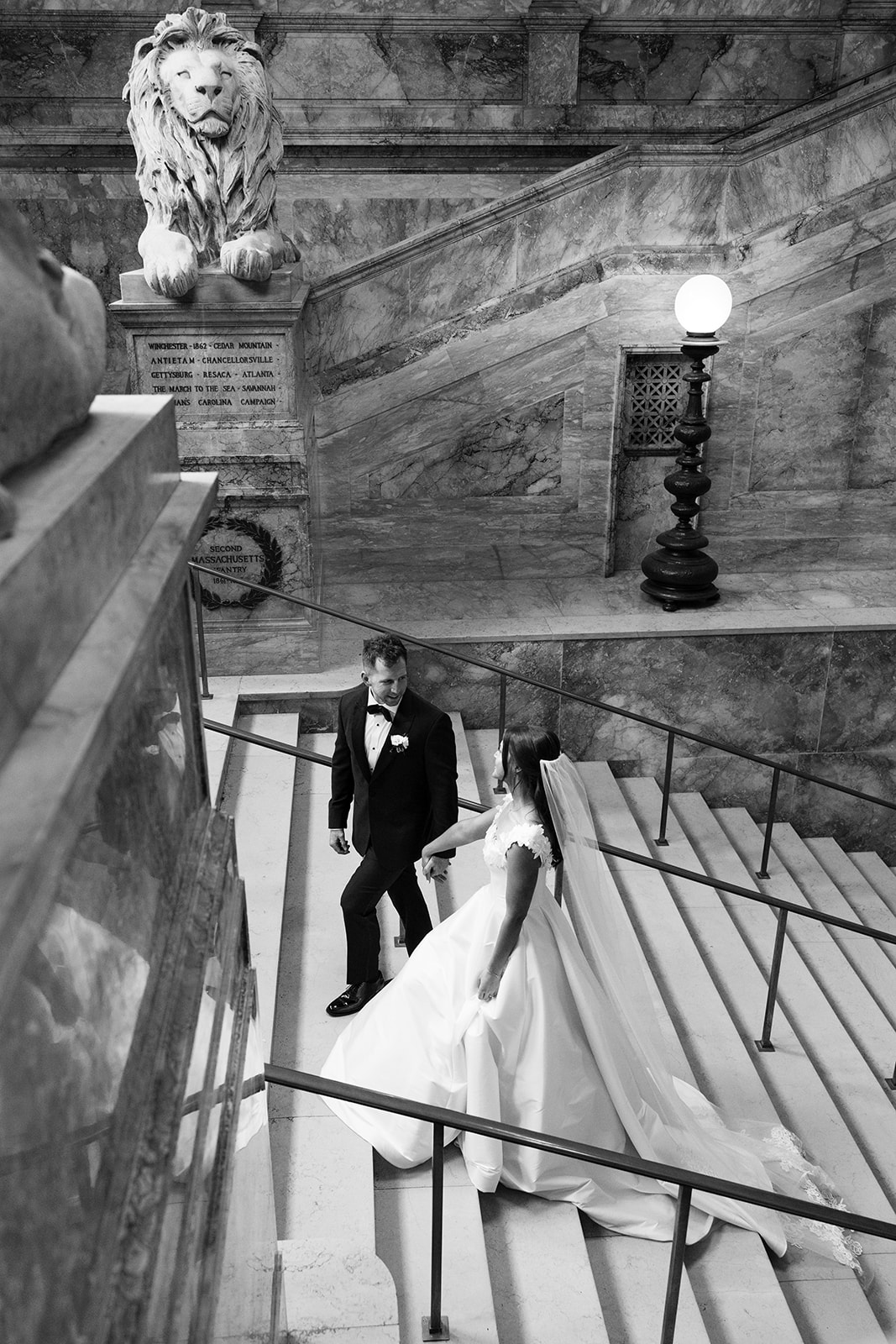 bride and groom walking through public library