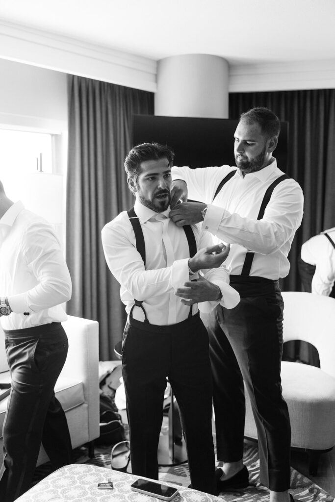 Groom adjusting his cufflinks at Westin Copley Place before the wedding ceremony