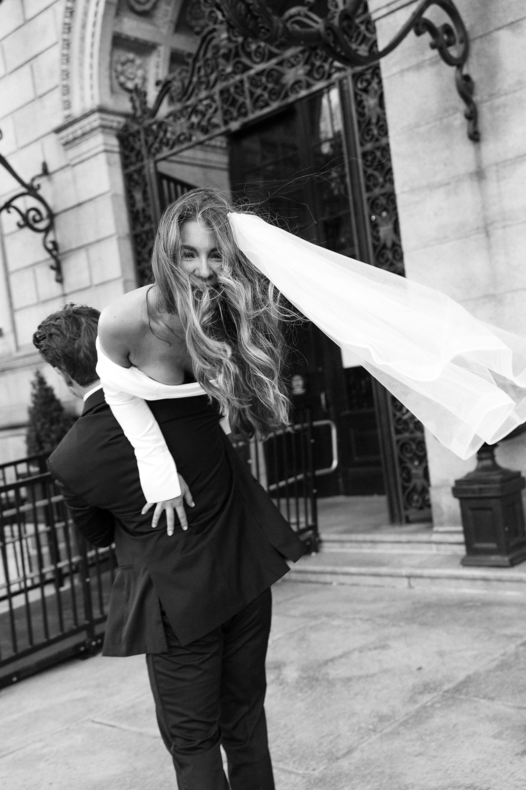 Romantic engagement photo in front of Boston Public Library archway