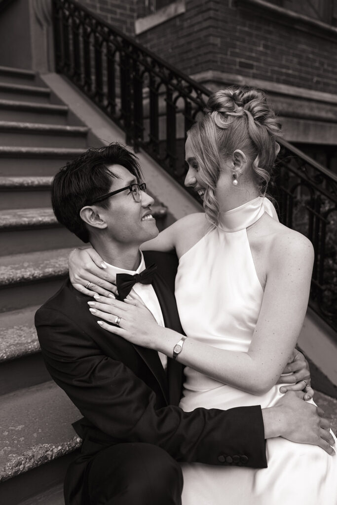 Couple sitting on Commonwealth Avenue brownstone steps during Boston elopement portraits