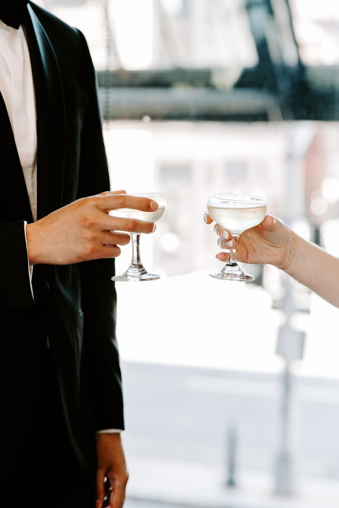 Bride and groom toasting with champagne coupes after their Boston elopement