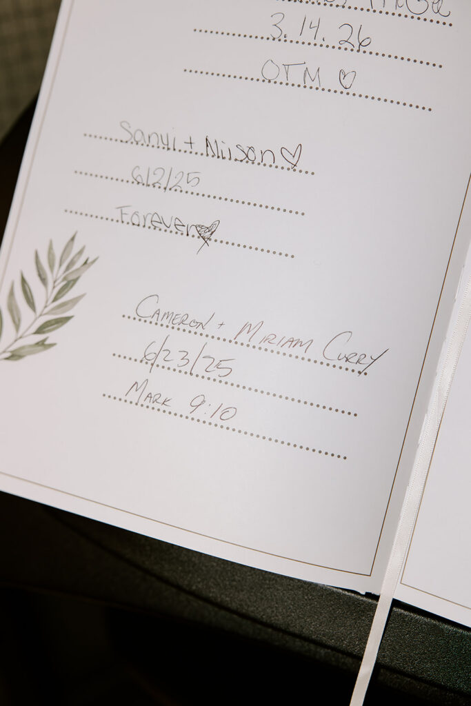 Close up of the Boston City Hall marriage registry with handwritten wedding date and Bible verse, intimate Boston City Hall wedding detail photographed by Boston wedding photographer Genevieve Photography